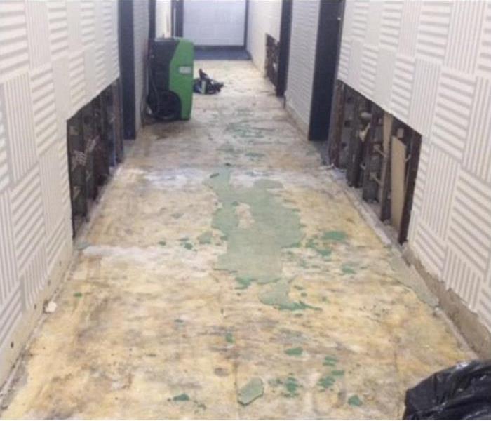 dehumidifier in a hallway, floor removed.